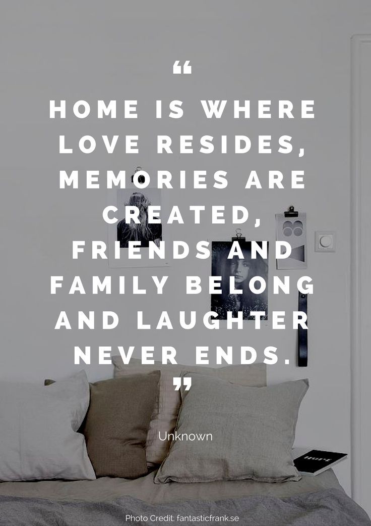 a bed with pillows on top of it next to a white wall and a quote that reads, home is where love resides