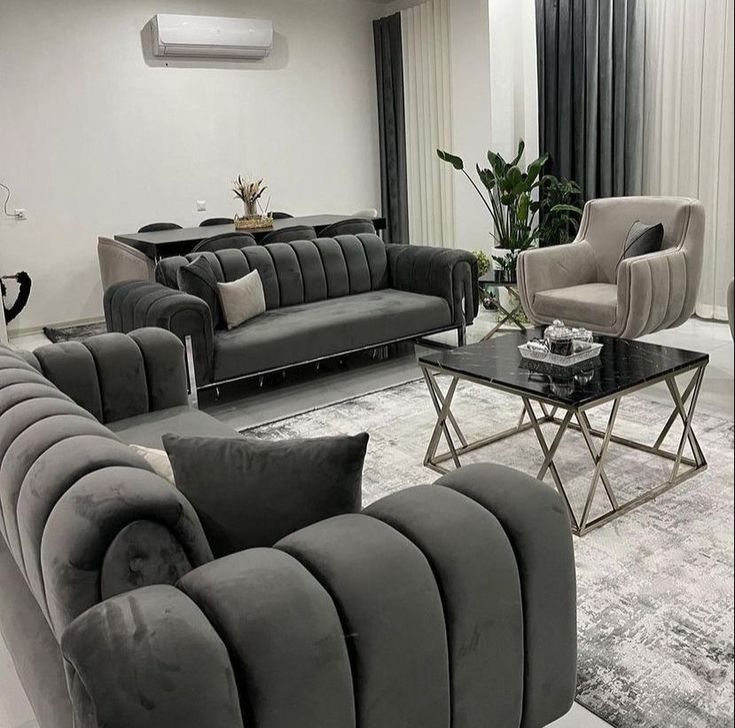 a living room filled with gray couches and chairs