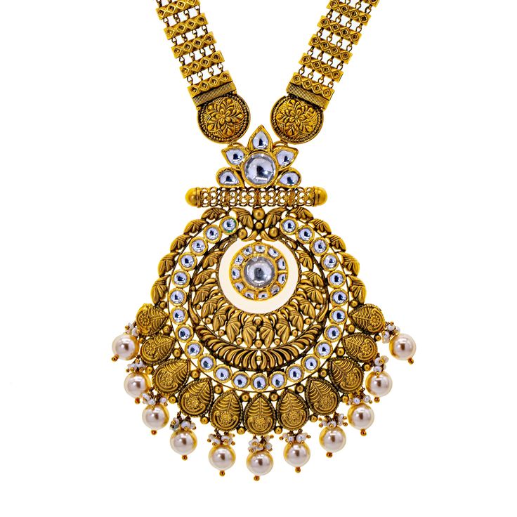 What better way to light up the room than with this exquisite 22k antique gold and kundan stone jewlery set from Virani. The bright kundan stones used in this bridal jewelry necklace and earring set perfectly compliment the 22k antique gold and beaded details. Features• 22k yellow gold• Kundan stonesVirani Jewelers bridal jewelry made from 22k gold brings together the beauty and significance of Indian culture and traditions. Find more beautiful 22k gold Indian bridal like this kundan stone neckl Ornate Gold Kundan Chandbalis, Yellow Gold Chandbali Kundan Temple Necklace, Hand Set Kundan Bridal Necklace In Yellow Gold, Ornate Gold Chandbalis With Kundan, 22k Gold Chandbali Bridal Necklace In Temple Jewelry Style, Kundan Bridal Necklace In Yellow Gold, 22k Gold Kundan Necklace With Intricate Temple Jewelry Design, 22k Gold Kundan Temple Necklace, Festive 22k Gold Kundan Necklace With Stone Work