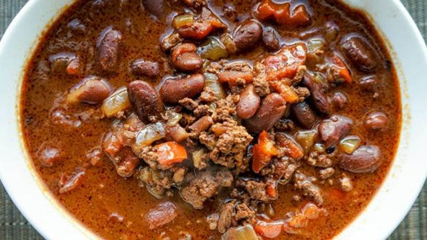 a white bowl filled with chili and beans