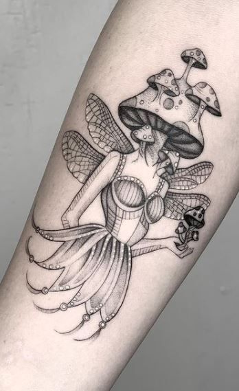 a woman's arm with a tattoo on it and mushrooms in the air above her