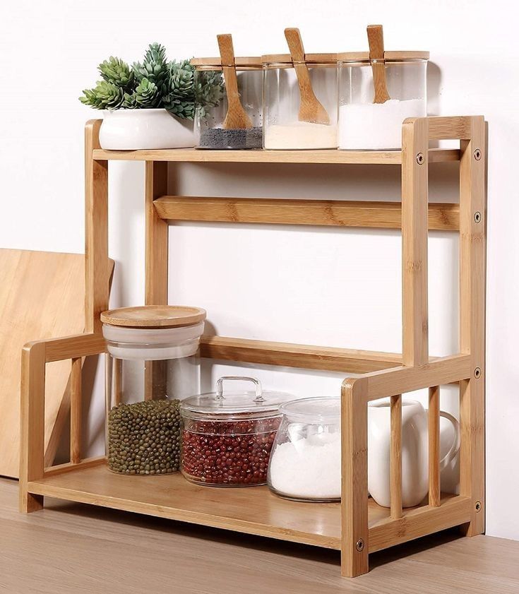 a wooden shelf with pots and pans on it