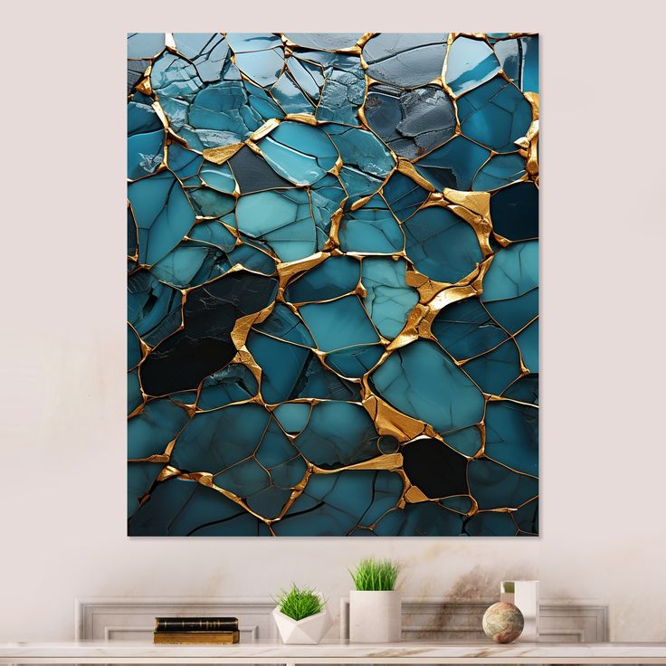 an abstract painting with blue and gold paint on the wall in a living room setting