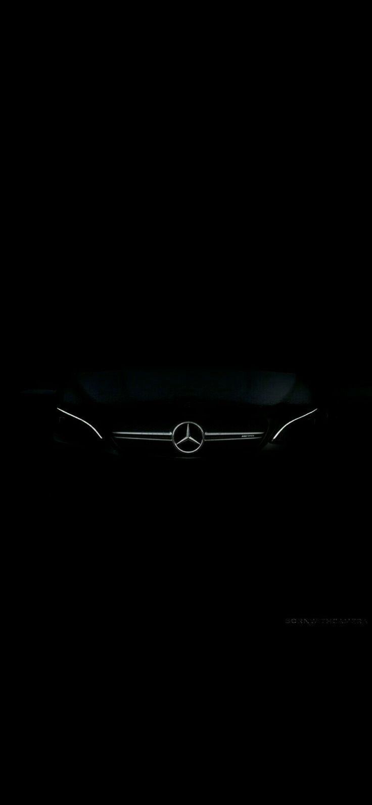 the mercedes logo is shown in the dark