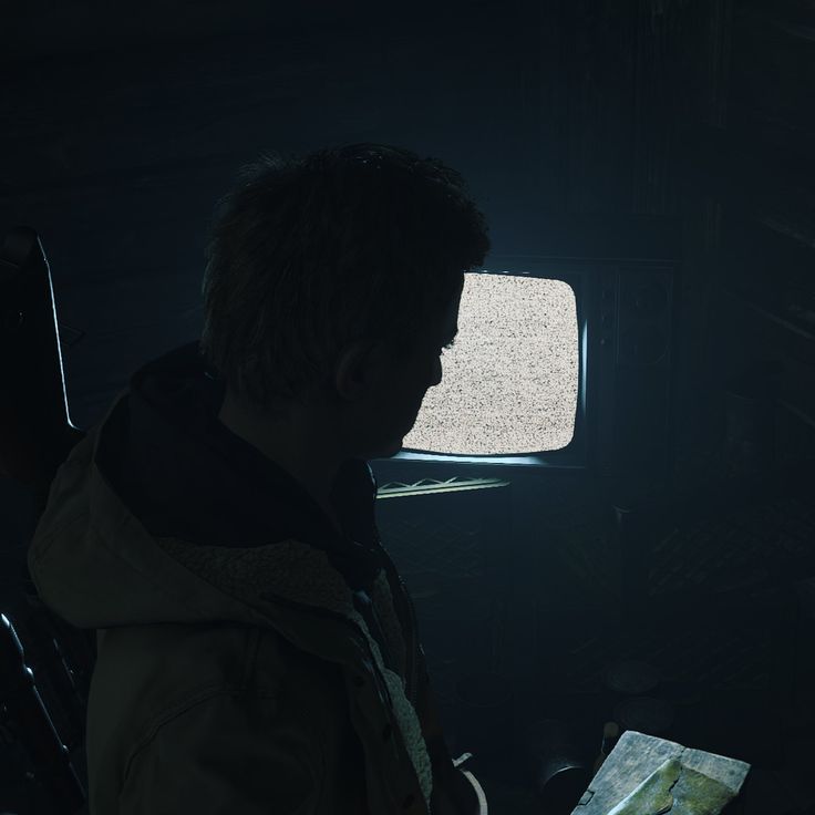 a person sitting in a chair looking at a map with the light shining on them