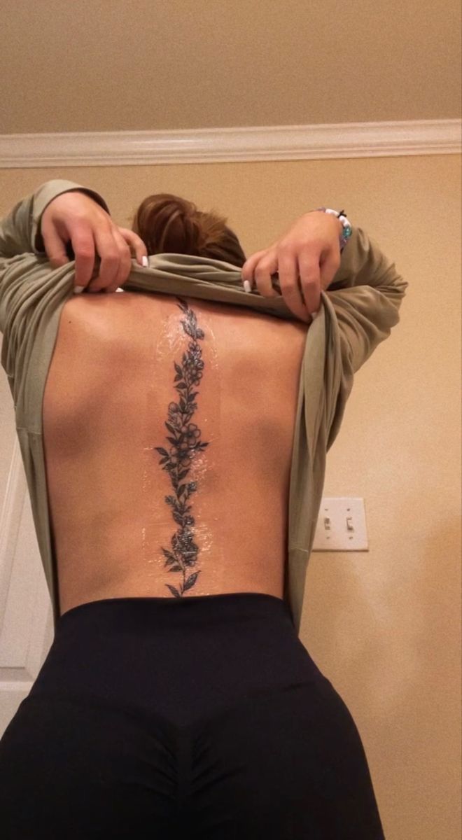 the back of a woman's body with flowers on it