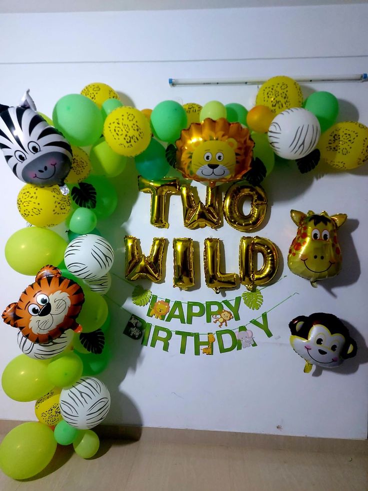 two wild happy birthday balloon arch with jungle animals and zebra balloons on the front wall