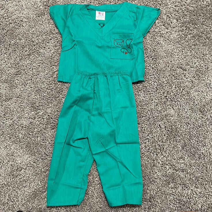 a green scrub suit laying on the floor