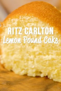 a close up of a piece of cake on a wooden table with the words ritz carlton lemon pound cake