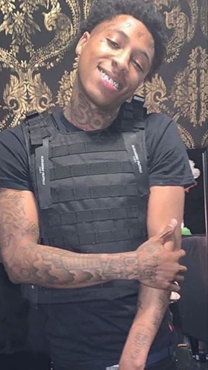 a man with tattoos on his arm and chest