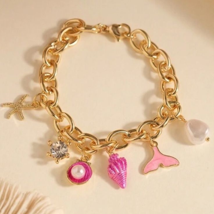 Pink Seashells, Pearls, And Gold Charm Bracelet For Sale! This Charm Bracelet Is New And Is From My Boutique! It Has Beautiful Shell Charms That Are Dangling From A Gold Chain! The Chain Is Made Out Of Stainless Steel. It Is Just Over 7 Inches Long When Unclasped. Such A Great Bracelet To Add To Your Jewelry Collection! Measurements: Bracelet Length: 7.2 Inches Trendy Pink Charm Bracelets, Trendy Pink Bracelets With Charms, Trendy Pink Metal Bracelets, Trendy Pink Metal Bracelet, Adjustable Pink Metal Charm Bracelet, Pink Metal Bracelets For Party, Pink Charm Bracelet For Beach, Pink Bracelet With Lobster Clasp For Party, Pink Metal Charm Bracelet With Charms