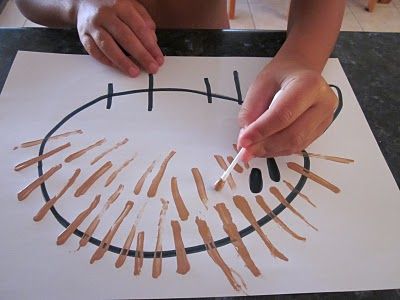 a child is making a paper circle with toothpicks