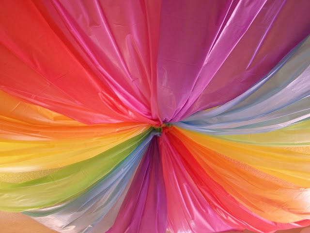 the inside of a multicolored paper umbrella