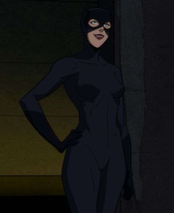 a woman in black catsuit standing next to a wall with her hands on her hips