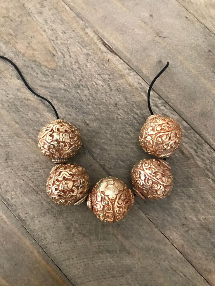 This listing is for 1 bead. These 24k gold washed copper beads were handcrafted in Nepal. Each bead is approximately 20x20 mm and weighs about 10.8 gm. Images may appear enlarged or smaller. Please refer to the measurements given. Please contact us for wholesale pricing on bulk orders. Large Bronze Round Beads, Bronze Jewelry With Large Beads, Traditional Brass Beads For Gifts, Gold Brass Beaded Necklace With Round Beads, Artisan Gold Necklace With Spacer Beads, Artisan Gold Necklaces With Spacer Beads, Artisan Gold Beaded Necklaces With Spacer Beads, Handmade Traditional Metal Beads, Traditional Handmade Metal Beads