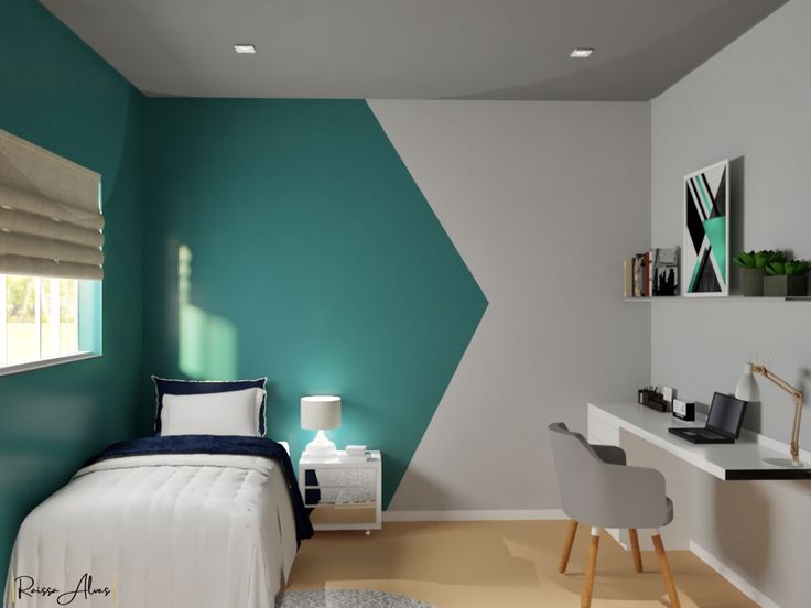 a bedroom with a bed, desk and chair next to a wall painted teal