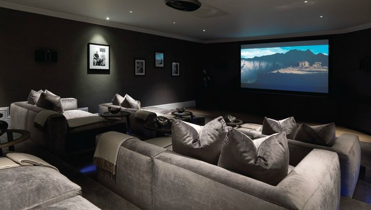 a large living room with couches and a projector in the middle of it