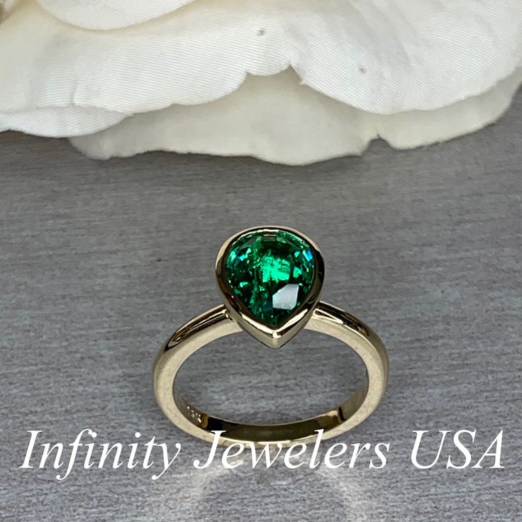 "The ring pictured is lab created emerald #7072 Rose Gold is available upon request as a custom order and is a final sale (non refundable, non returnable, non exchangeable). -Approximate total carat weight: approx. 2.10ctw diamond equivalent -Center Stone Size: 10x7mm - approx. 2.10ct diamond equivalent -Center Stone Shape: pear shape -Gem Type: lab created emerald -Stone Clarity: VS2 -Stone Color: Green -Moh's Scale: 8.5 hardness -Metal Type and Purity: 14k yellow gold -Setting: bezel set -Stoc Classic Green Teardrop Emerald Ring, Heart Cut Emerald Jewelry For May Birthstone, Green Teardrop Emerald Ring For May Birthstone, Emerald Ring With Bezel Setting For Anniversary, May Birthstone, Green Heart Cut Emerald Ring For Formal Occasions, Heart Cut Green Emerald Ring For Formal Occasions, Green Solitaire Teardrop Jewelry, Pear-shaped Emerald Ring In 14k Gold, Heart Cut Emerald Green Jewelry