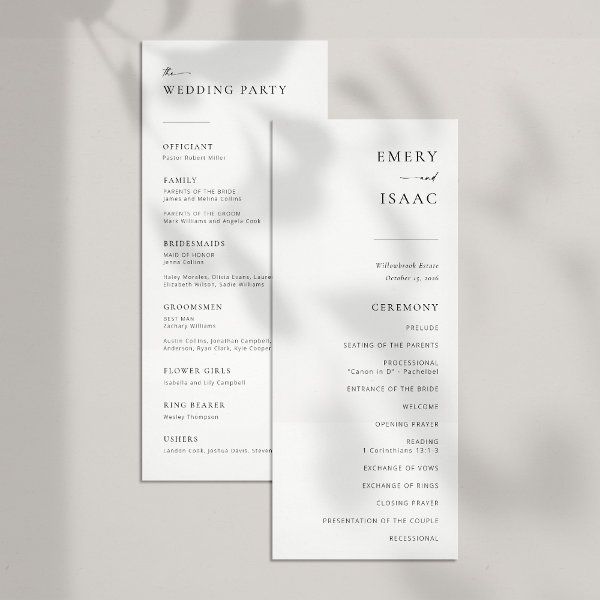 two white wedding program cards on a table