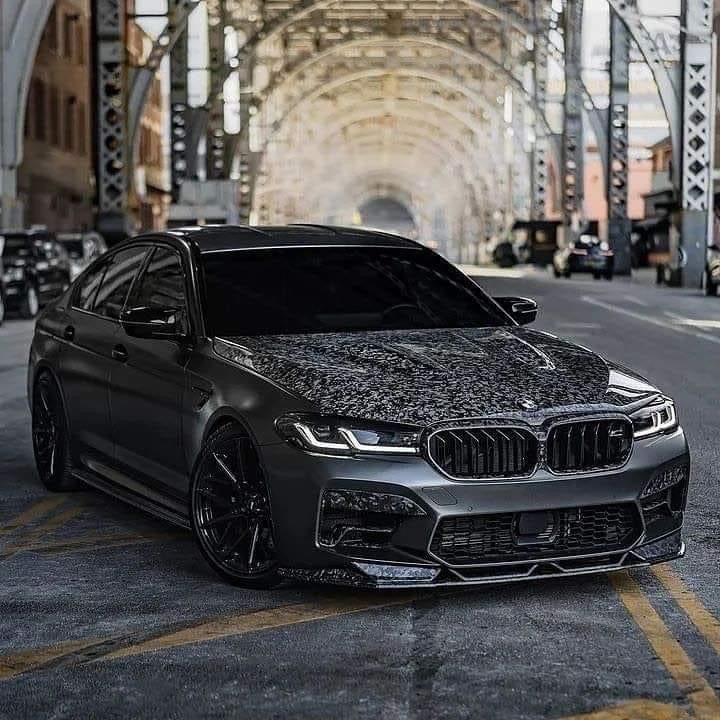 a black car parked in front of a tunnel