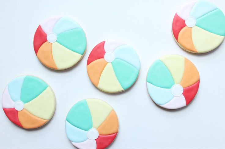 four decorated cookies with different colored designs on them