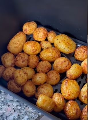 potatoes being cooked in an air fryer