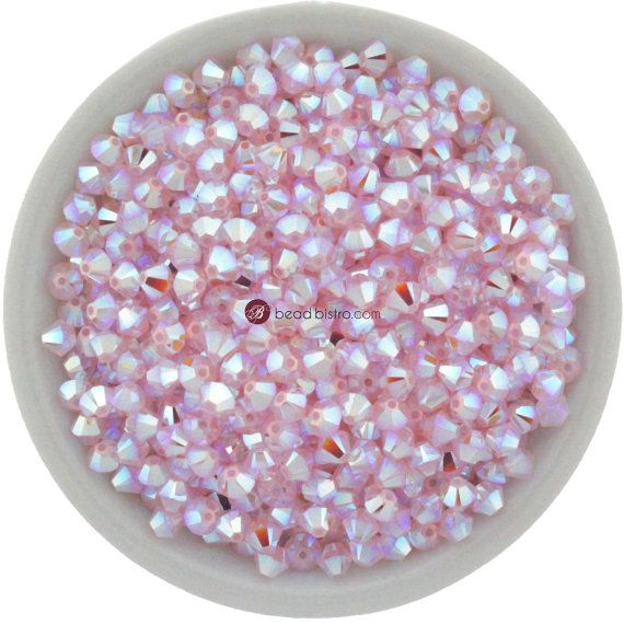 a bowl filled with pink and white beads