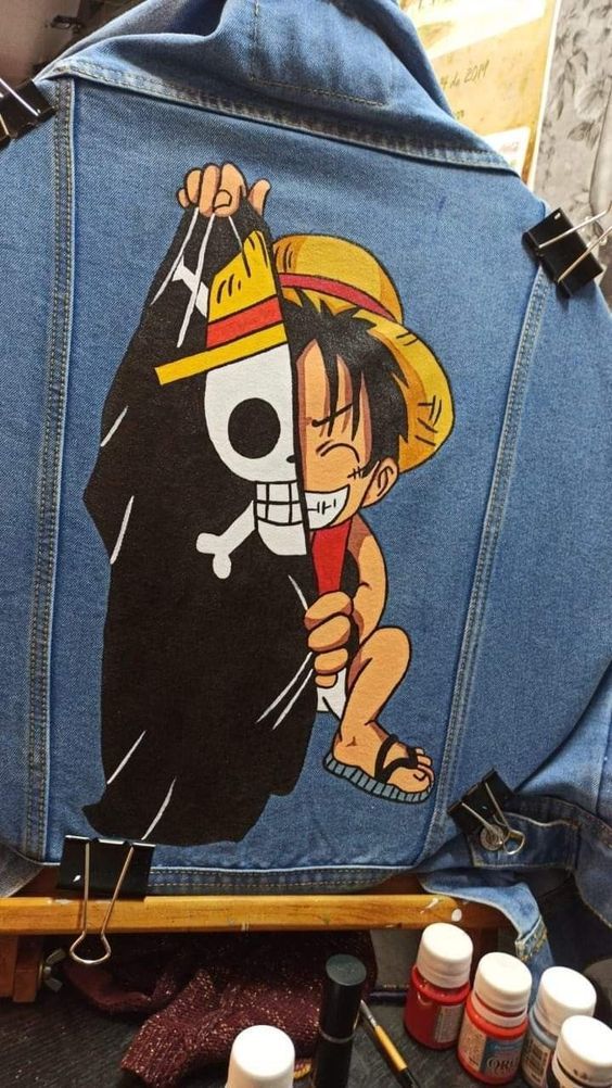 the back of a jean jacket with an image of a cartoon character on it