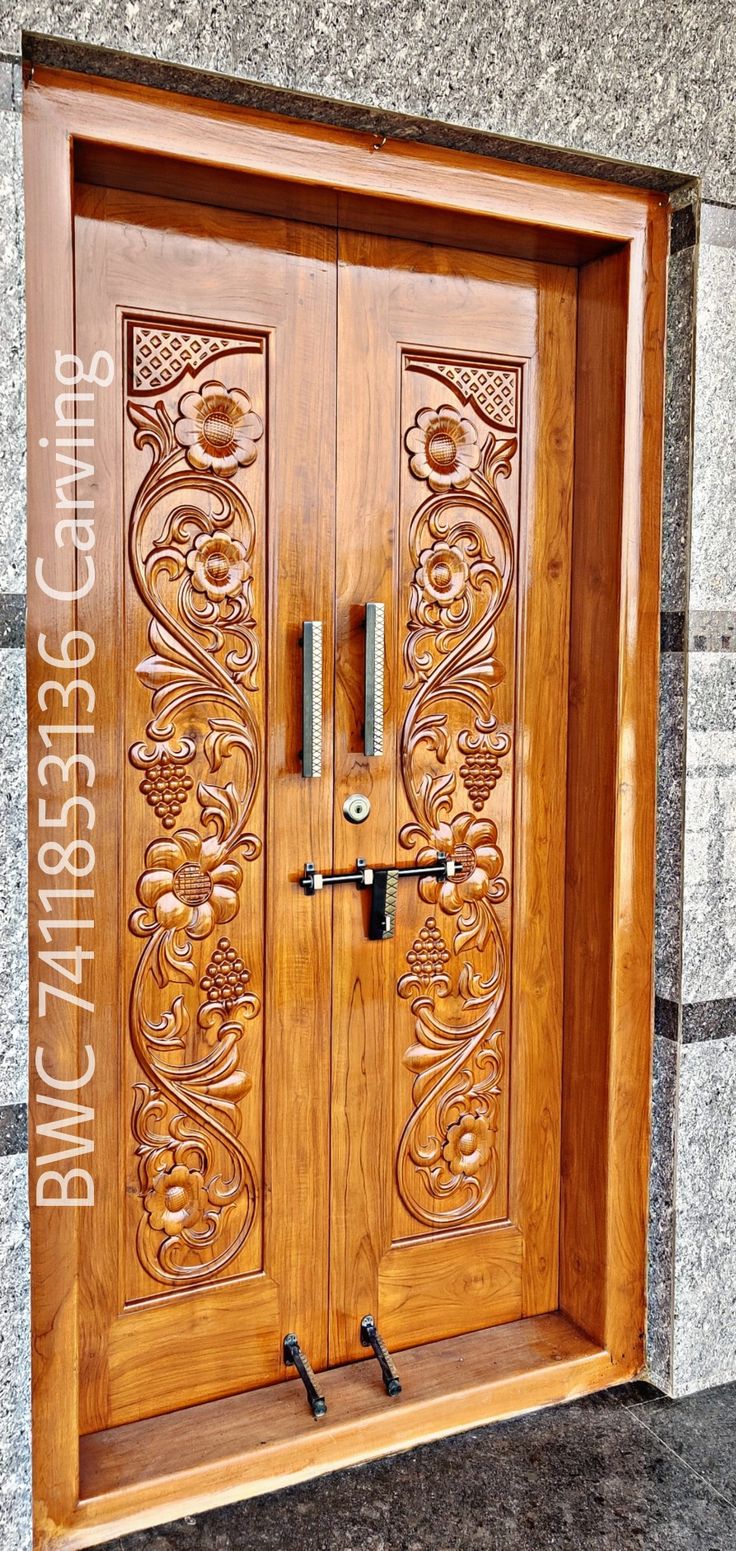 an ornate wooden door on the side of a building