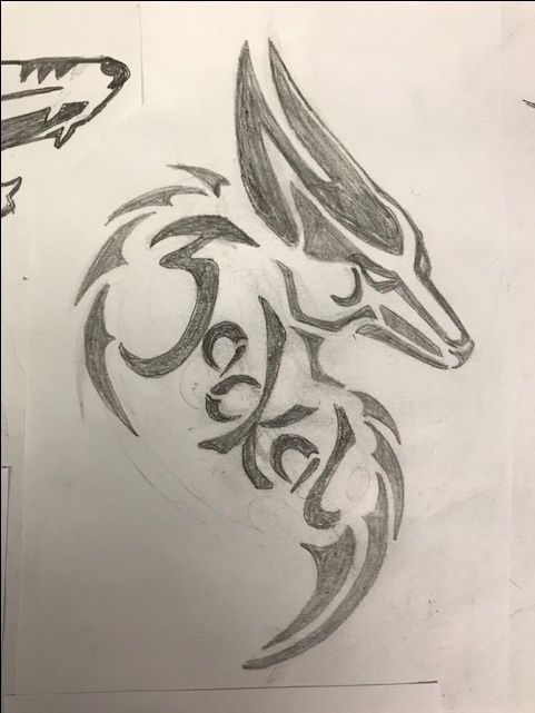 a drawing of a wolf head on paper