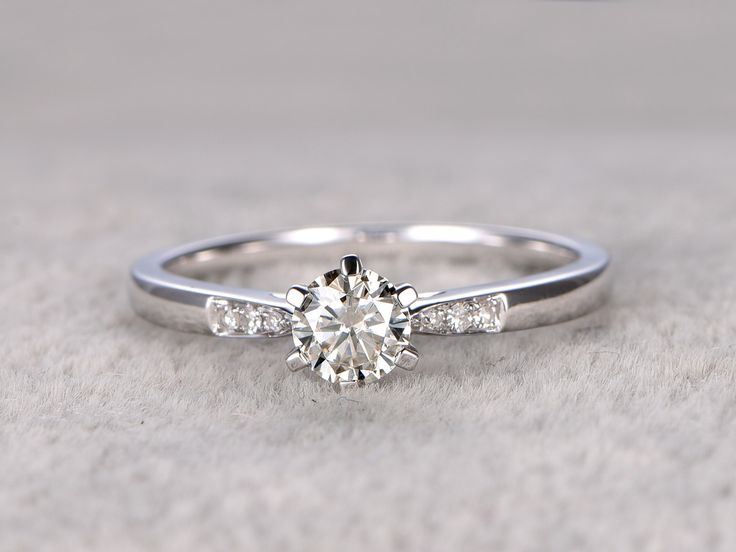 a white gold engagement ring with diamonds on it