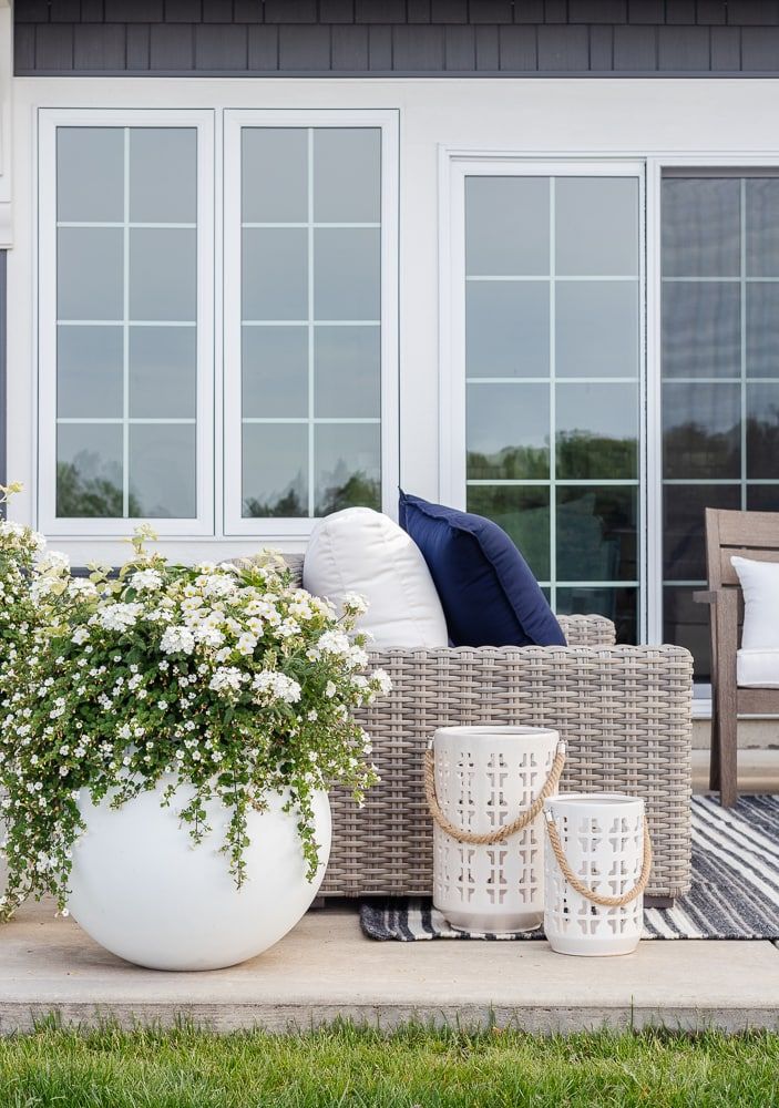 a large white vase sitting on top of a patio