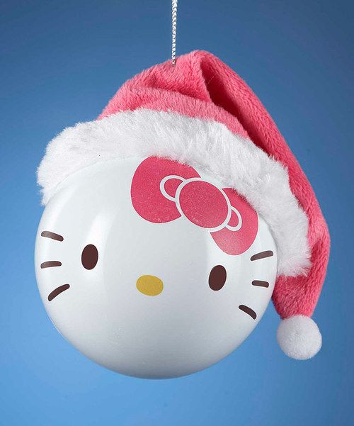 a hello kitty christmas ornament hanging from a string with a santa hat on it