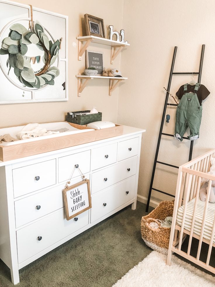 a baby's room with a dresser, crib, and changing table in it