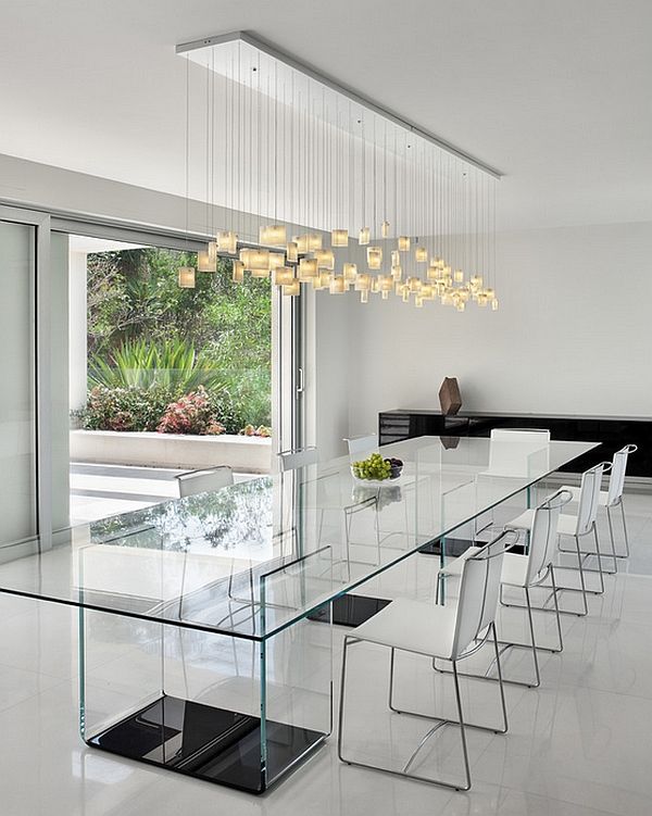 a modern dining room with glass table and white chairs