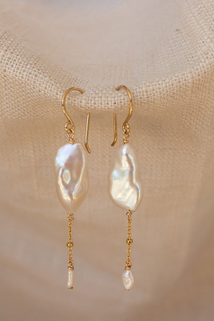 Inspired by the dreamy feeling of looking up into the clouds, the Cloud Collection reimagines historical jewelry elements resulting in timeless, airy, and whimsical jewelry that will have you floating on cloud nine. A freshwater pearl is not mined and shaped. It is born complete and lovely, beneath the water. Baroque pearls are especially "wabi sabi," beautiful in their asymmetry and each one of a kind. ﻿- 17mm / 6mm freshwater pearls﻿- 18k Vermeil ﻿- About 2" long 14k Gold-filled Yellow Gold Drop Pearl Earrings, Handmade Delicate Yellow Gold Pearl Earrings, Delicate Handmade Yellow Gold Pearl Earrings, Delicate Baroque Pearl Earrings, Graceful Yellow Gold Jewelry With Pearl Drop, Graceful Yellow Gold Pearl Drop Jewelry, Timeless Pearl Charm Drop Jewelry, 14k Gold Long Drop Pearl Earrings, Delicate Akoya Pearl Earrings