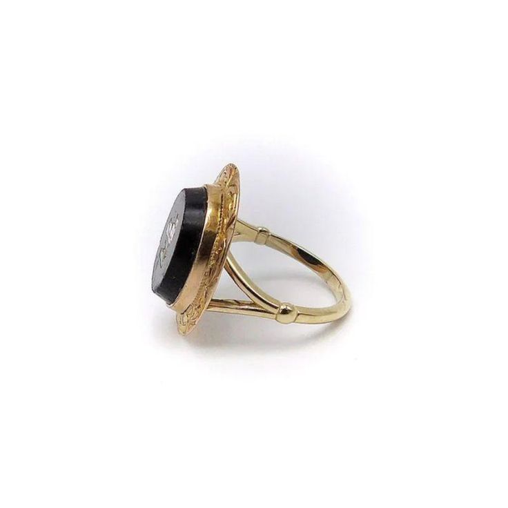 This is part of Chairish’s Fine Jewelry assortment.  This is a beautiful 14k gold ring that is part of our Signature Collection. There is a 14k split shank that has been attached to a Victorian era micro mosaic bird set in a tablet of onyx and surrounded by a hand engraved 14k gold border. The onyx tablet measures 13mm by 15mm and the ring is a size 5 1/2.  The bird is made using a painstaking technique that involves creating an image out of small pieces of opaque enamel glass called tesserae. T Elegant Gold Ring For Memorial, Heirloom Ring Jewelry For Memorial, Victorian Memorial Jewelry Ring, Victorian 14k Gold Cabochon Jewelry, Victorian Style 14k Gold Cabochon Jewelry, Heirloom 14k Gold Jewelry For Memorial, Fine Jewelry: 14k Gold With Intaglio Detail, Fine Jewelry 14k Gold With Intaglio, Fine 14k Gold Jewelry With Intaglio