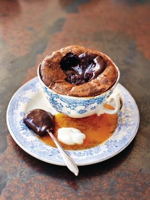 a cup filled with some kind of dessert on top of a saucer