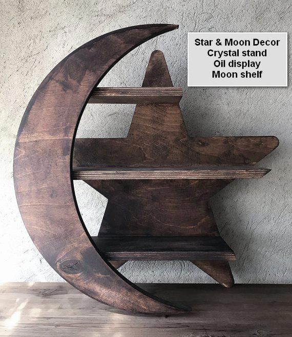 a wooden moon and star decoration on top of a shelf