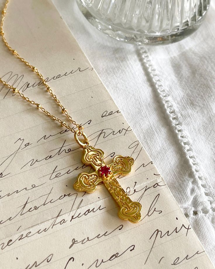 The Luxe Cross Necklace is a vintage French style for our Parisian hearts. A romantic cross 18kt gold plated silver 22x31mm with pink cubic zirconia  stone 3mm. . Gold fiilled chain 16, 18 or 20 inches long. All items come in a gift box ready to gift. To see more please visit  https://www.etsy.com/shop/BijouLimon Bijou Limon jewelry collections present a romantic French spin on the latest jewelry trends. Based on the US West Coast but French at heart, Bijou Limon interprets the current jewelry t Vintage French Style, Latest Jewellery Trends, Turquoise Stud Earrings, Stacked Necklaces, Gold Cross Necklace, French Wedding, Rococo Style, Stacked Jewelry, Vermeil Jewelry