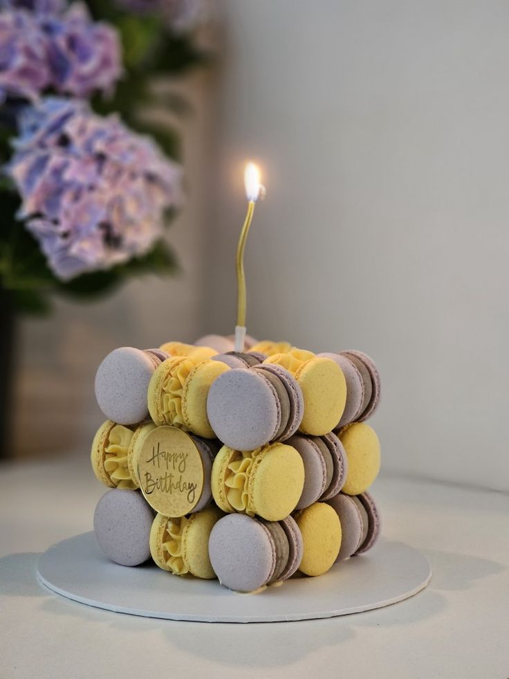 a birthday cake made out of cookies with a single candle