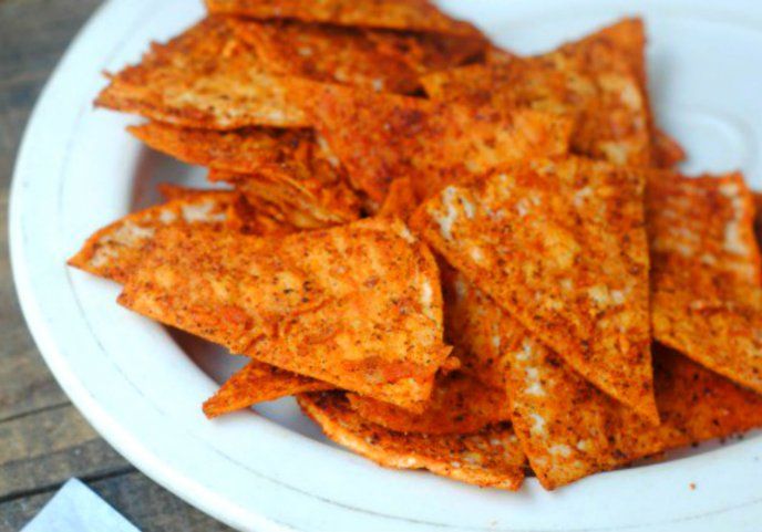 some tortilla chips on a white plate