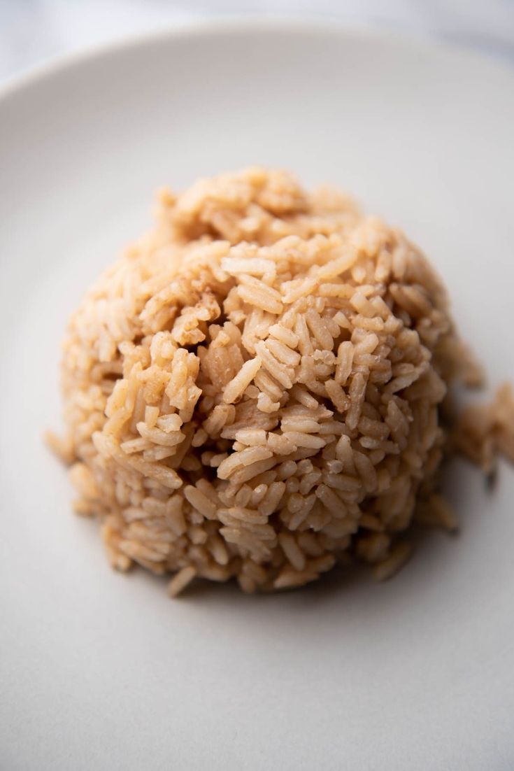 a white plate topped with rice on top of a table