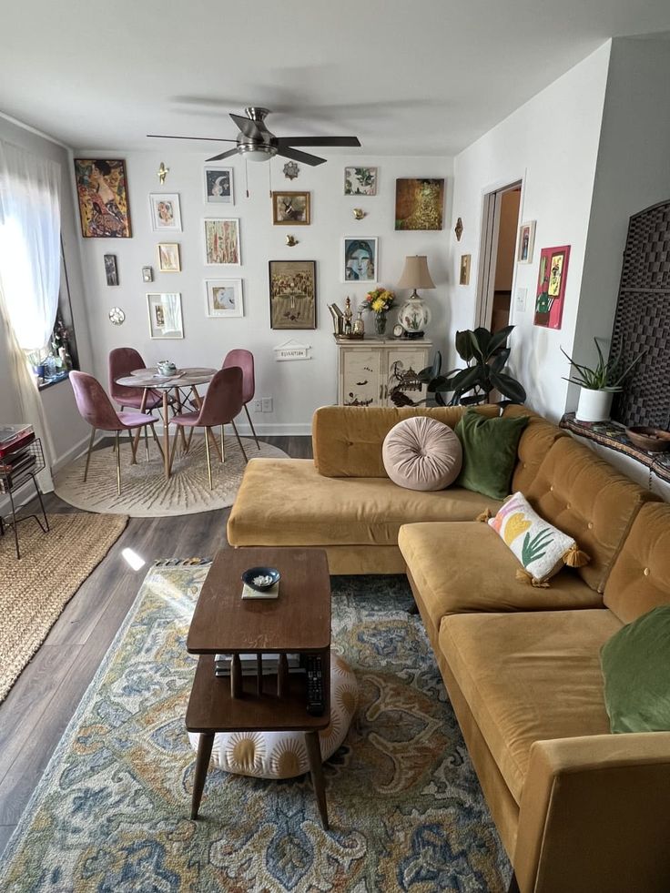 a living room filled with furniture and lots of pictures hanging on the wall above it