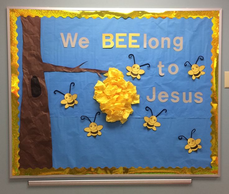 a bulletin board with paper flowers and bees on it that says, we bee long to jesus