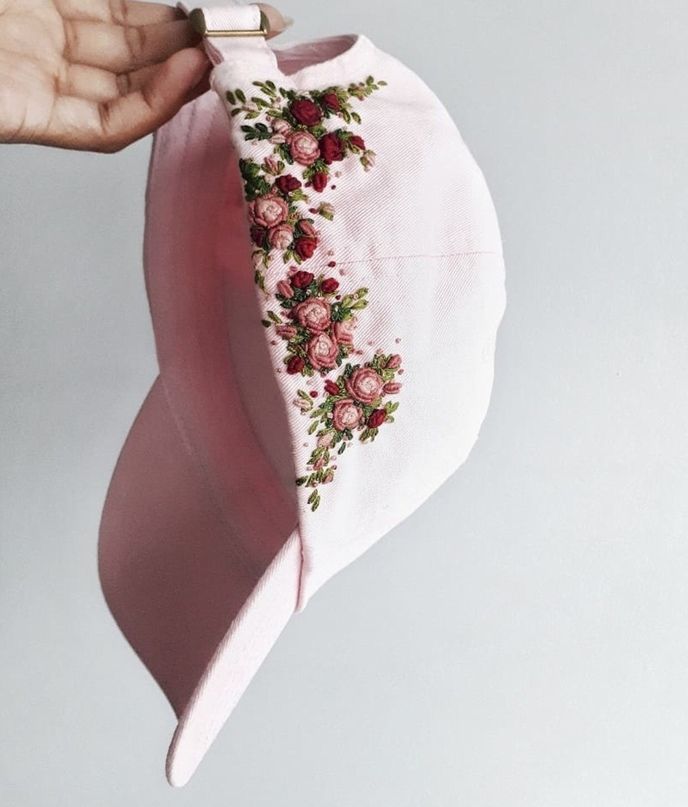 a hand holding a pink cloth with flowers on it