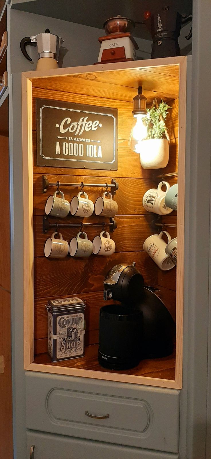 the coffee shop has many cups and mugs on display in its cabinet, as well as an assortment of other items