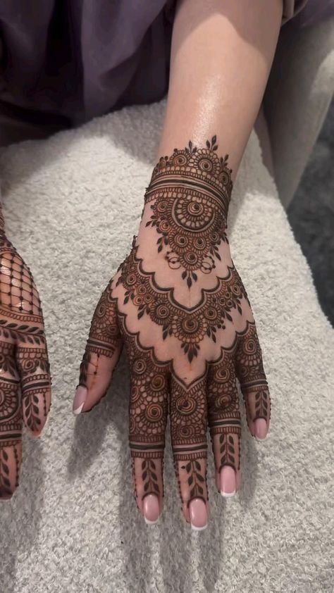 two hands with henna designs on them