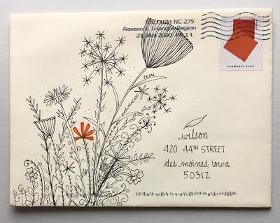 an envelope with a drawing of flowers on it