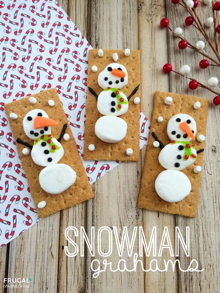 three homemade snowman graham crackers on a wooden table